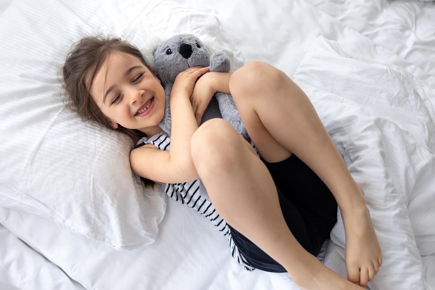 happy little girl with soft toy koala bed 1 Mattress Sizes Mattress Sizes MATTRESS SIZES