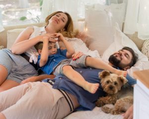 high angle family staying caravan bed with dog high-angle-family-staying-caravan-bed-with-dog