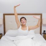 pretty girl stretching bed 2 How Choosing the Right Mattress Can Improve Mood