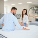 woman with her husband furniture store showroom 1 Guide to Buying a Mattress The Complete Guide to Buying a Mattress: Comfort, Support, and Materials